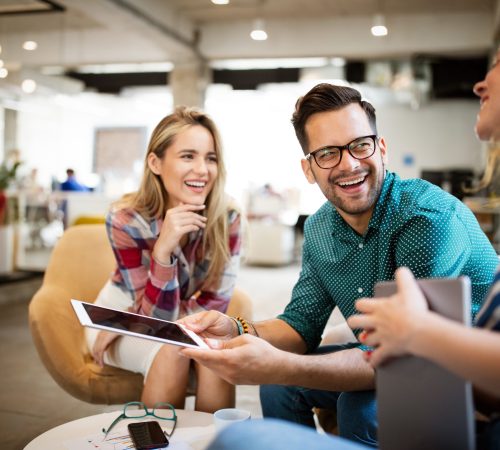 Business people, designers having fun and chatting at workplace office