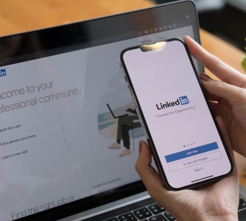 CHIANG MAI, THAILAND, OTC 17, 2021 : A women holds Apple iPhone 13 Pro Max with LinkedIn application on the screen.LinkedIn is a photo-sharing app for smartphones.